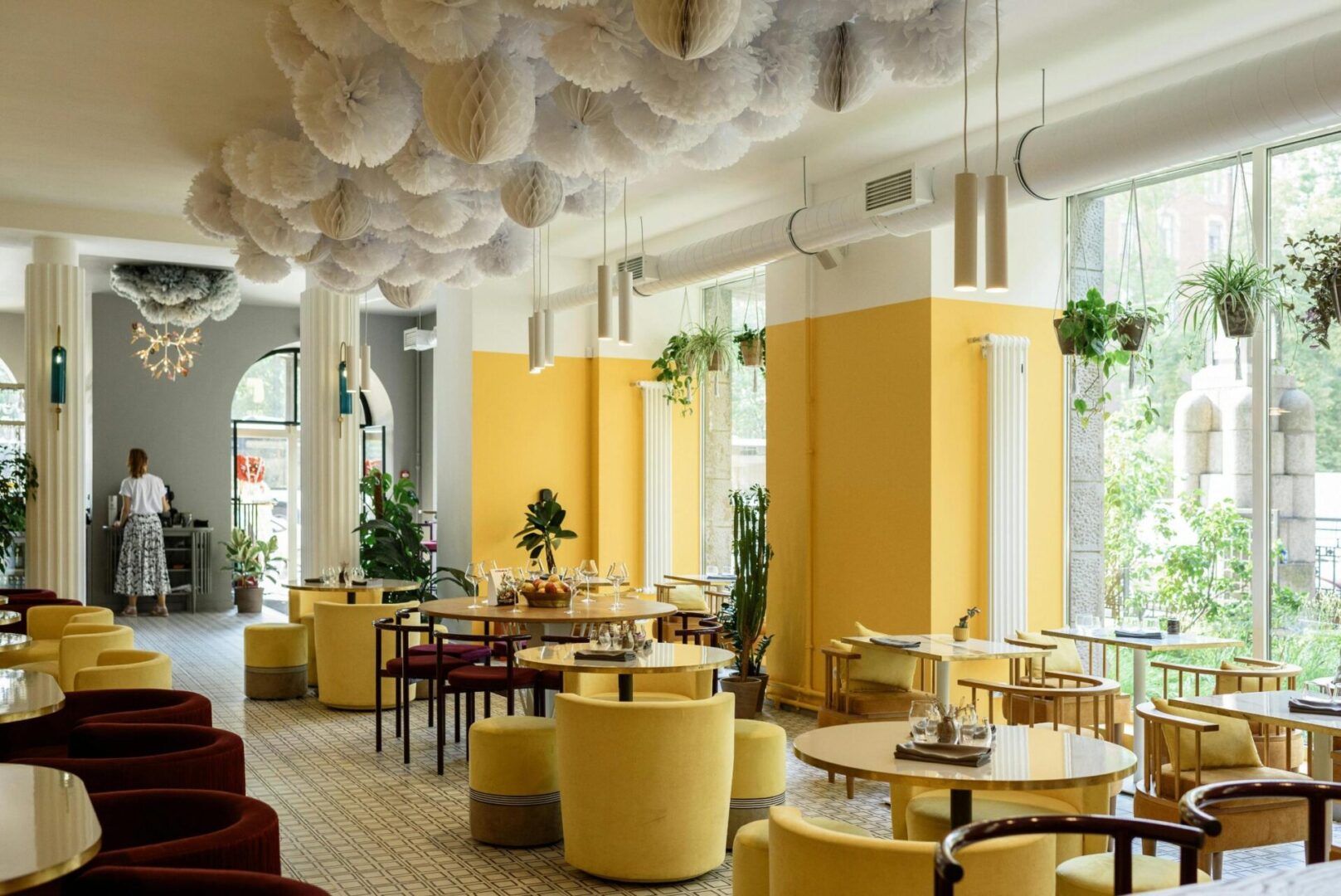 A restaurant with yellow walls and tables